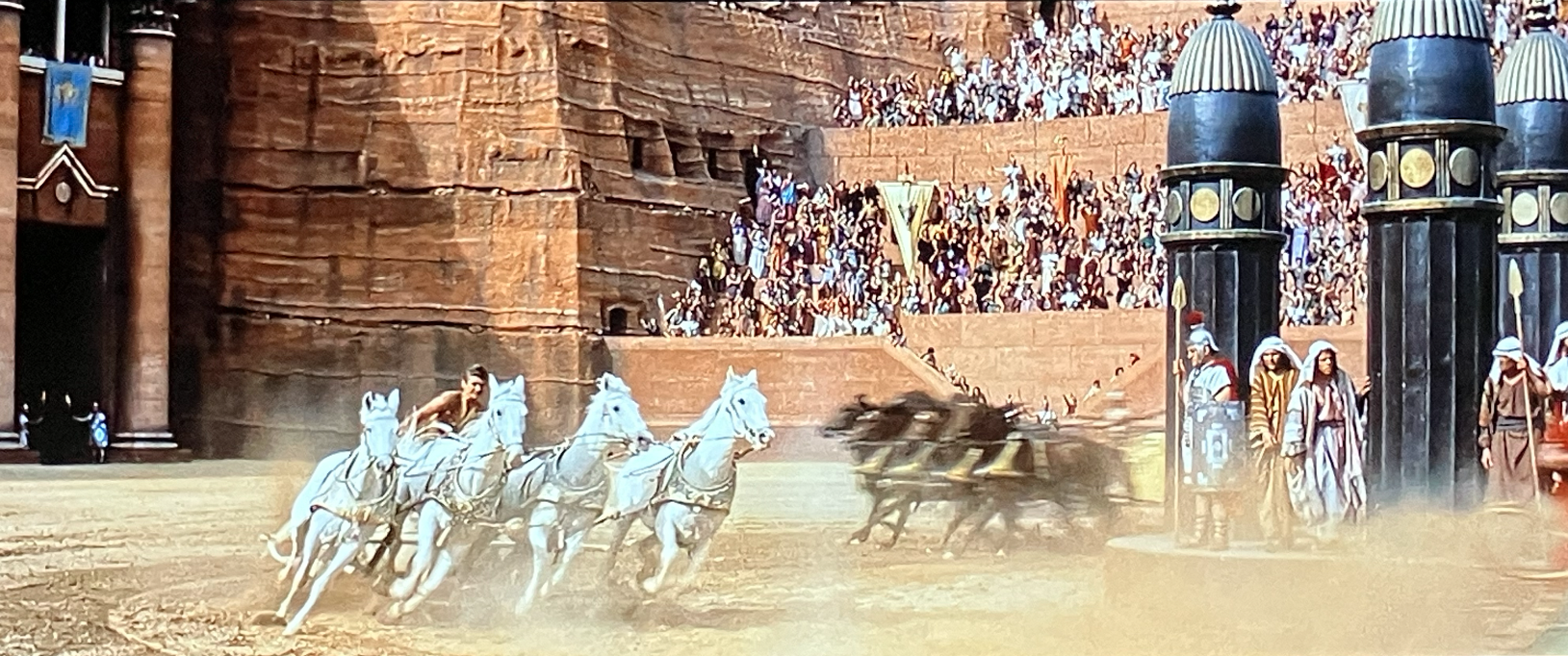 Ben Hur driving his chariot in the race under the watchful eye of Pontius Pilate